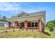 Charming brick home with a covered front porch and freshly landscaped yard at 1220 Hightower Nw Rd, Atlanta, GA 30318