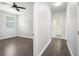 Hallway view into bedroom with hardwood floors, ceiling fan, and natural light at 1220 Hightower Nw Rd, Atlanta, GA 30318