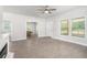 Sunlit living room with an adjacent kitchen, features a ceiling fan, wood-look floors at 1220 Hightower Nw Rd, Atlanta, GA 30318