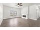 Bright living room features a decorative fireplace, ceiling fan, and wood-look flooring at 1220 Hightower Nw Rd, Atlanta, GA 30318