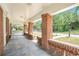 Covered front porch with brick columns and slate tile flooring, perfect for relaxing outdoors at 1220 Hightower Nw Rd, Atlanta, GA 30318