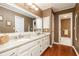 Double vanity bathroom with granite countertops and wood flooring at 1111 Valley Ridge Se Ct, Marietta, GA 30067