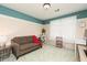 Cozy bedroom with teal and beige walls and a brown couch at 1111 Valley Ridge Se Ct, Marietta, GA 30067