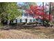 Two-story house with blue shutters, landscaping, and a tree with red leaves at 1111 Valley Ridge Se Ct, Marietta, GA 30067