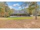 Beautiful home with a covered front porch, three dormer windows, and a well-manicured lawn at 3380 Wildwood Rd, Suwanee, GA 30024