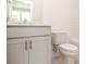 Bathroom featuring a grey vanity with white quartz countertops, along with a matching toilet at 516 Healy Dr # 69, Cumming, GA 30040