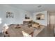 Open living room with hardwood floors, a brown couch, and a view of the kitchen at 1122 Westchester Ne Rdg, Atlanta, GA 30329