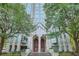 Stately building entrance with large wooden doors, grand architecture, and lush landscaping at 2870 Pharr Court S Nw # 2703, Atlanta, GA 30305
