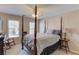 Bedroom featuring a four-poster bed and rocking chair at 1750 Terrace Lake Dr, Lawrenceville, GA 30043