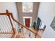 View of the home's entryway, showcasing a grand staircase and crystal chandelier at 1750 Terrace Lake Dr, Lawrenceville, GA 30043