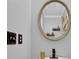 Small bathroom with a round mirror and updated fixtures at 361 W Post Oak Sw Xing, Marietta, GA 30008