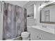 Clean bathroom with shower/tub combo, vanity, and linen storage at 361 W Post Oak Sw Xing, Marietta, GA 30008