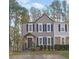 Two-story townhome with gray siding, black shutters, and a landscaped yard at 361 W Post Oak Sw Xing, Marietta, GA 30008