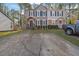 Charming townhome with gray siding, stone accents, and a paved driveway at 361 W Post Oak Sw Xing, Marietta, GA 30008