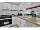 Galley kitchen with white cabinets and stainless steel appliances at 361 W Post Oak Sw Xing, Marietta, GA 30008