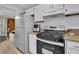 Galley kitchen with white cabinets and stainless steel appliances at 361 W Post Oak Sw Xing, Marietta, GA 30008