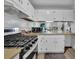 Galley kitchen with white cabinets, stainless steel appliances, and a double sink at 361 W Post Oak Sw Xing, Marietta, GA 30008