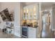 Stylish bar area with glass-front cabinets, a wine fridge, and elegant countertops at 4738 Ivy Ridge Se Dr, Atlanta, GA 30339