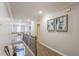 Bright hallway with hardwood floors, neutral paint and access to a staircase, several bedrooms, and a gorgeous light fixture at 4738 Ivy Ridge Se Dr, Atlanta, GA 30339