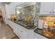 Granite counters and backsplash accent this kitchen with gas range and white cabinetry at 4738 Ivy Ridge Se Dr, Atlanta, GA 30339