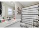 Clean bathroom with white vanity and striped shower curtain at 51 Jennifer Ln, Rydal, GA 30171