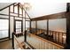 Open loft overlooking the lower level with wooden railings and a chandelier at 8441 Lake Dr, Snellville, GA 30039