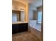 Bathroom with double vanity, soaking tub, and tile floors at 1212 Lake Point Way, Suwanee, GA 30024