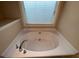 Relaxing bathroom with soaking tub and window at 1212 Lake Point Way, Suwanee, GA 30024