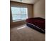 Spacious bedroom with plush carpet and window at 1212 Lake Point Way, Suwanee, GA 30024