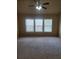 Large bedroom with carpeted floors and three windows at 1212 Lake Point Way, Suwanee, GA 30024