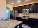 Modern kitchen with stainless steel appliances and granite countertops at 1212 Lake Point Way, Suwanee, GA 30024