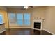 Bright living room featuring a corner fireplace and hardwood floors at 1212 Lake Point Way, Suwanee, GA 30024