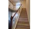 Elegant staircase with wooden railings and carpeted steps at 1212 Lake Point Way, Suwanee, GA 30024