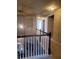 Upstairs hallway with neutral walls and carpeted floors at 1212 Lake Point Way, Suwanee, GA 30024