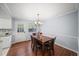 Cozy dining room with hardwood floors, a classic chandelier, and a view of the outdoor scenery at 2946 N Dekalb Dr # Apt C, Atlanta, GA 30340