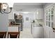 Bright kitchen featuring white cabinetry, granite counters, and stainless steel appliances adjacent to the dining area at 2946 N Dekalb Dr # Apt C, Atlanta, GA 30340