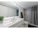 Bright bathroom features a large vanity mirror, walk-in shower with sleek gray curtain at 2870 Pharr Court South Nw # 2602, Atlanta, GA 30305