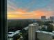 Cityscape view from a window at sunset with a colorful sky backdrop and some water droplets on the window at 2870 Pharr Court South Nw # 2602, Atlanta, GA 30305