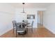 Cozy dining area with table for four, adjacent to kitchen, with natural light and hardwood floors at 2870 Pharr Court South Nw # 2602, Atlanta, GA 30305