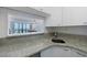 Kitchen bar open to the living room features sleek faucet and granite countertops at 2870 Pharr Court South Nw # 2602, Atlanta, GA 30305