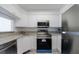 Efficient kitchen with stainless steel appliances, white cabinets, and granite countertops at 2870 Pharr Court South Nw # 2602, Atlanta, GA 30305
