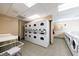 Well-lit laundry room offers multiple washers and dryers for resident convenience at 2870 Pharr Court South Nw # 2602, Atlanta, GA 30305