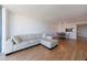 Spacious living room with wood floors, open to dining area, featuring a comfortable white sectional sofa at 2870 Pharr Court South Nw # 2602, Atlanta, GA 30305