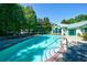 Community pool with lap lanes, patio, lounge chairs, and shade at 2870 Pharr Court South Nw # 2602, Atlanta, GA 30305