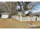 Fenced backyard featuring a shed, mature trees, and manicured landscaping at 8671 Lake Forrest Dr, Douglasville, GA 30134