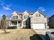 Two-story brick home with a large front yard and attached garage, car parked in driveway at 7860 Bristol Valley Dr, Cumming, GA 30028
