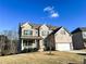 Two-story brick home with a large front yard and attached garage at 7860 Bristol Valley Dr, Cumming, GA 30028