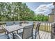 Outdoor dining space on back deck with seating and beautiful, wooded backyard views at 207 Eagles Flight, Villa Rica, GA 30180