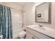 Bathroom featuring a single sink vanity, framed mirror, and a shower-tub combo at 207 Eagles Flight, Villa Rica, GA 30180
