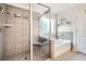 Bathroom featuring glass shower with seat, soaking tub, and neutral tile at 207 Eagles Flight, Villa Rica, GA 30180